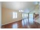 Open living room with hardwood floors, plantation shutters, built-in shelving, and a sliding door at 1417 E Marshall Ave, Phoenix, AZ 85014