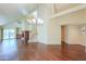 Open-concept living space with hardwood floors, vaulted ceilings, and natural light from large windows at 1417 E Marshall Ave, Phoenix, AZ 85014