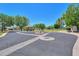 Community street view featuring a circular landscaped area and mature trees under a bright blue sky at 1417 E Marshall Ave, Phoenix, AZ 85014