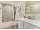 This bathroom has a bathtub with a shower, a vanity and tiled flooring at 1619 E Aspen Ave, Buckeye, AZ 85326