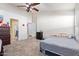 Bedroom with a bed, a dresser, an ensuite bath and carpet flooring at 1619 E Aspen Ave, Buckeye, AZ 85326