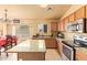 Modern kitchen featuring stainless steel appliances and granite countertops adjacent to dining area at 1619 E Aspen Ave, Buckeye, AZ 85326