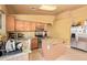 Efficient kitchen featuring modern stainless steel appliances, and functional island for meal preparation at 1619 E Aspen Ave, Buckeye, AZ 85326