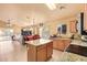 Well-equipped kitchen with granite countertops and island, seamlessly connected to the dining area at 1619 E Aspen Ave, Buckeye, AZ 85326