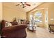 Cozy living room with a large window and vaulted ceiling, perfect for relaxing and entertaining at 1619 E Aspen Ave, Buckeye, AZ 85326