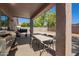 Covered patio with a stainless steel grill and table at 1619 E Aspen Ave, Buckeye, AZ 85326