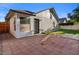Backyard view featuring a brick patio, artificial turf, and access door at 1736 E Bluefield Ave, Phoenix, AZ 85022