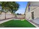The backyard view features a retaining wall, artificial turf, and gravel at 1736 E Bluefield Ave, Phoenix, AZ 85022