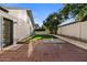 Private backyard with a paved patio area, artificial turf, and mature trees for shade at 1736 E Bluefield Ave, Phoenix, AZ 85022