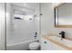 Updated bathroom featuring white subway tile, modern fixtures, and a wood-accented vanity at 1736 E Bluefield Ave, Phoenix, AZ 85022