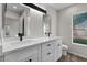 Modern bathroom features a double sink vanity with white cabinets and stylish black hardware at 1736 E Bluefield Ave, Phoenix, AZ 85022