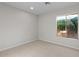 Bright bedroom with neutral carpet and a window offering a view of lush greenery at 1736 E Bluefield Ave, Phoenix, AZ 85022