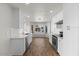 Stylish white kitchen features stainless steel appliances, bright lighting, and a view to the front yard at 1736 E Bluefield Ave, Phoenix, AZ 85022