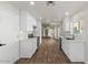 Spacious kitchen with white cabinets, wood-look tile flooring, and stainless steel appliances at 1736 E Bluefield Ave, Phoenix, AZ 85022