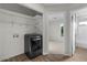Laundry room with a modern washer/dryer and storage shelves for added convenience at 1736 E Bluefield Ave, Phoenix, AZ 85022