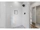 Modern shower stall with white subway tile, black fixtures, and a stone-look tile floor at 1736 E Bluefield Ave, Phoenix, AZ 85022