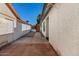 Tiled entryway with a narrow side yard featuring rock landscaping and a privacy fence at 1736 E Bluefield Ave, Phoenix, AZ 85022