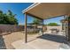 A cozy covered patio area with outdoor grill, leading to a refreshing above-ground pool and landscaped backyard at 17611 W Watson Ln, Surprise, AZ 85388