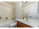 A functional bathroom featuring a vanity with sink, toilet, and shower-tub combination, offering essential amenities at 17611 W Watson Ln, Surprise, AZ 85388