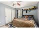 A bedroom decorated with construction toys, ceiling fan, and gray walls, creating a playful and inviting space at 17611 W Watson Ln, Surprise, AZ 85388