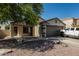 Inviting single-story home with a two-car garage and gravel landscaping at 17611 W Watson Ln, Surprise, AZ 85388