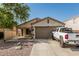 Charming single-Gathering home featuring a well-manicured yard and spacious two car garage at 17611 W Watson Ln, Surprise, AZ 85388