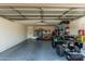 A well-organized garage featuring ample storage solutions and space for an ATV at 17611 W Watson Ln, Surprise, AZ 85388