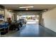 Spacious garage with overhead door open featuring ample room for vehicles and storage at 17611 W Watson Ln, Surprise, AZ 85388
