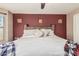 Comfortable main bedroom featuring a red accent wall and soft decor creates a relaxing retreat at 17611 W Watson Ln, Surprise, AZ 85388