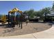 Community playground with colorful structures and a sand base for safe play at 17611 W Watson Ln, Surprise, AZ 85388