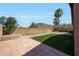 Landscaped backyard featuring artificial turf, pavers, and block wall at 18371 W Capistrano Ave, Goodyear, AZ 85338