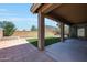 Covered patio overlooking a backyard with synthetic turf, pavers, and a mountain view at 18371 W Capistrano Ave, Goodyear, AZ 85338