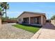 Beautiful backyard offers gravel, artificial turf, and covered patio at 18371 W Capistrano Ave, Goodyear, AZ 85338