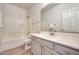 Bathroom featuring a modern vanity with double sinks, large mirror and shower-tub combination at 18371 W Capistrano Ave, Goodyear, AZ 85338