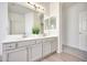 Bright bathroom features a dual sink vanity with modern fixtures and ample counter space at 18371 W Capistrano Ave, Goodyear, AZ 85338