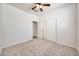 Neutral bedroom featuring a ceiling fan, closet with sliding doors, and doorway to other rooms at 18371 W Capistrano Ave, Goodyear, AZ 85338
