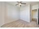 Clean bedroom features a ceiling fan, carpeted floor, and closet at 18371 W Capistrano Ave, Goodyear, AZ 85338