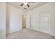 Neutral bedroom featuring a ceiling fan, closet with sliding doors, and doorway to other rooms at 18371 W Capistrano Ave, Goodyear, AZ 85338