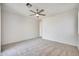 Spacious bedroom featuring a ceiling fan, bright windows, and doorway to other rooms at 18371 W Capistrano Ave, Goodyear, AZ 85338