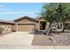 Inviting single-Gathering home featuring a neutral color palette, two-car garage, and low-maintenance landscaping at 18371 W Capistrano Ave, Goodyear, AZ 85338