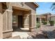 Charming front porch with decorative columns and detailed stucco, offering a welcoming entrance to the home at 18371 W Capistrano Ave, Goodyear, AZ 85338