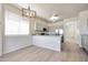 Well lit kitchen with stainless appliances, eat in counter, and wood look floors in an open concept floorplan at 18371 W Capistrano Ave, Goodyear, AZ 85338
