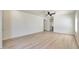 Open living room with wood-look floors, neutral paint, and a ceiling fan that provides comfort and style at 18371 W Capistrano Ave, Goodyear, AZ 85338