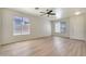 Bright and spacious living room with neutral walls, wood-look floors, and large windows for natural light at 18371 W Capistrano Ave, Goodyear, AZ 85338