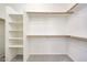 Walk-in closet with built-in shelving and rods to maximize storage space at 18371 W Capistrano Ave, Goodyear, AZ 85338