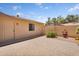 Enclosed backyard features a brick patio, private access door, and minimal xeriscape landscaping at 18416 N Spanish Garden Dr, Sun City West, AZ 85375