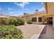 Private backyard features a brick patio, mature landscaping, and sunny skies at 18416 N Spanish Garden Dr, Sun City West, AZ 85375