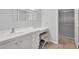 Bright bathroom with a white vanity, large mirror, and accessible shower at 18416 N Spanish Garden Dr, Sun City West, AZ 85375