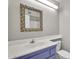 Bathroom featuring vibrant blue cabinetry, stylish mirror, and modern fixtures at 18416 N Spanish Garden Dr, Sun City West, AZ 85375