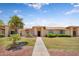 Charming single-story home with mature palm trees and well-maintained landscaping at 18416 N Spanish Garden Dr, Sun City West, AZ 85375